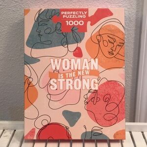 Perfectly Puzzling 1000 piece “Woman is the New Strong” puzzle. New in box.